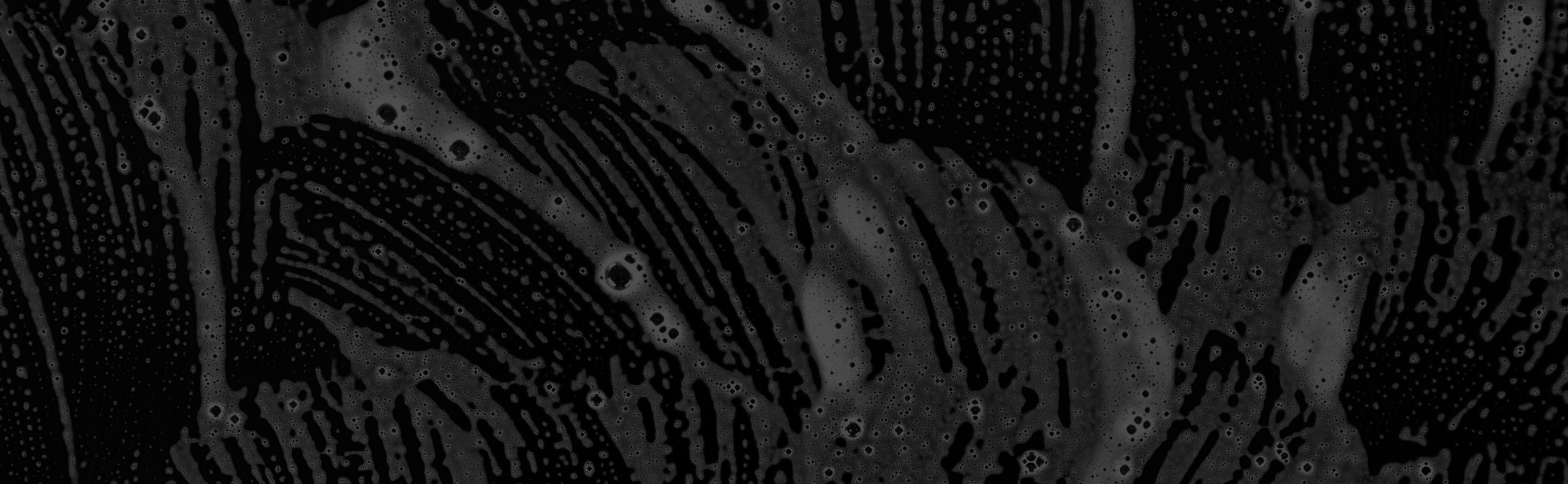 background-with-white-soap-foam-on-black-surface